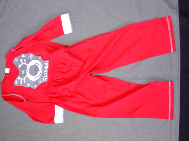KNITTED PYJAMAS FOR UNISEX.  T-SHIRT STYLE UPPER.  ROUND NECK WITHOUT OPENING.  LONG SLEEVES. WITH FAKE FUR TRIM AT ENDS.  HEMMED  AT BASE. WITH RUDOLPH DESIGN ON FRONT.  PACKED IN PLASTIC BAG, WITH TROUSERS OF SAME FABRIC.  ELASTICATED WAIST WITHOUT OPENING.  HEMMED AT LEG ENDS.  100% POLYESTER.