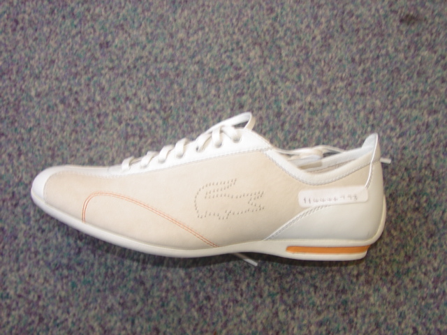 LADIES SHOE. NOT COVERING THE ANKLE. UPPERS OF LEATHER. OUTER SOLES OF RUBBER. WITH LOGO ON UPPER AND TONGUE. LACE UPS. INSOLE LENGTH EXCEEDING 24 CMS. WHITE/BEIGE/ORANGE IN COLOUR.