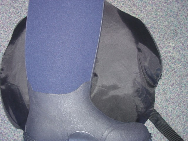A WATERPROOF BOOT COVERING THE ANKLE BUT NOT COVERING THE KNEE. UPPER IS MADE OF NEOPRENE AND LOWER PART OF THE BOOT IS MADE OF RUBBER. SOLE IS MADE OF RUBBER WITH A HEAVY TREAD FOR GRIP TO WITHSTAND WET WEATHER CONDITIONS.