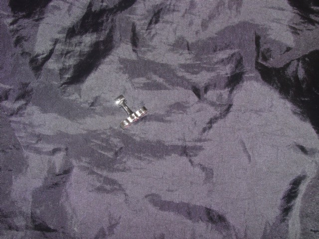 IMITATION JEWELLERY. INJECTION MOULDED BASE METAL CUFF-LINK. RHODIUM PLATED. SET WITH PINK ENAMEL AND CRYSTALS.