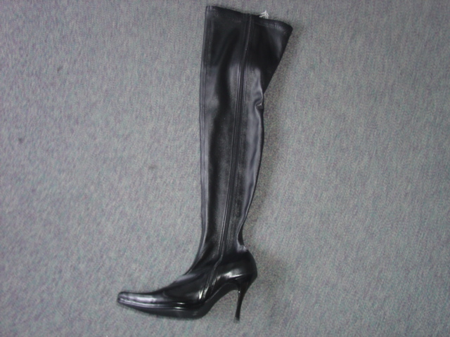 LADIES THIGH HIGH FASHION BOOT. UPPERS OF PLASTIC. OUTER SOLES OF PLASTIC. WITH FULL LENGTH ZIP FASTENING DOWN ONE SIDE AND STILLETTO TYPE HIGH HEEL (MEASURING 9.5 CMS). BLACK IN COLOUR.