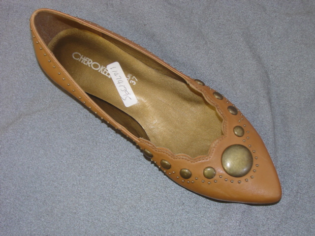 WOMENS  CASUAL SLIP ON SHOE. NOT COVERING THE ANKLE. UPPERS OF  LEATHER.  OUTER SOLES OF PLASTIC/RUBBER. IN SOLE LENGTH 24CM. NOT SPECIAL TECHNOLOGY FOOTWEAR. VARIOUS SIZED STUDS FORMING A PATERN ON THE VAMP AND SMALL STUDS AROUND THE TOP OF THE SHOE SHOE.
