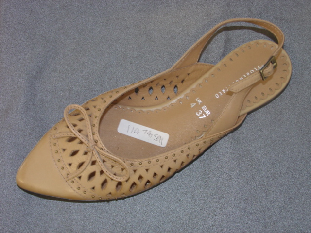 WOMENS CASUAL SLIP ON SHOE. NOT COVERING THE ANKLE. UPPERS OF  LEATHER.  OUTER SOLES OF PLASTIC/RUBBER. BACKLESS. BUCKLE FASTENING STRAP AROUND THE BACK OF THE HEEL. IN SOLE LENGTH 24CM. NOT SPECIAL TECHNOLOGY FOOTWEAR. VARIOUS SIZED STUDS FORMING A PATERN ON THE VAMP AND SMALL STUDS AROUND THE TOP OF THE SHOE.