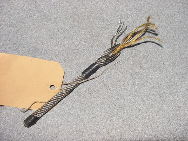 STEEL WIRE ROPE/CABLE. OVERALL DIAMETER 8mm.  CONSISTING OF FIVE STRANDS OF YELLOW FIBRE IN A TWISTED FORMATION. SURROUNDED BY SIX STRANDS WIRE IN A TWISTED FORMATION. SURROUNDED IN TURN BY TWELVE STRANDS OF WIRE ALSO IN A TWISTED FORMATION IN THE OPPOSITE DIRECTION. EACH STRAND OF WIRE CONSISTS OF SEVEN SMALL UNIFORM WIRES. ALL  OF MILD STEEL. OVERALL DIAMETER 8mm. EACH STRAND APPROX. 1.5mm. AND EACH WIRE APPROX. 0.5mm. DIAMETER. NOT FOR USE IN CIVIL AIRCRAFT. NOT CONSIGNED FROM MOLDOVA OR MOROCCO.