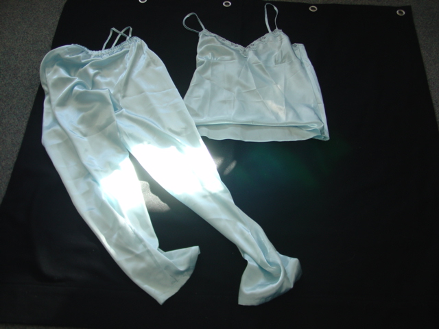 WOVEN SATIN STYLE PYJAMAS FOR WOMEN.  CONSISTING OF A CHEMISE STYLE TOP.  V-NECK WITHOUT OPENING WITH DECORATIVE LACE STYLE TRIM AT FRONT OF NECK.  WITH ADJUSTABLE SHOULDER STRAPS.  HEMMED AT BASE.  PACKED WITH TROUSERS OF IDENTICAL FABRIC.  ELASTICATED WAIST WITHOUT OPENING.  HEMMED AT LEG ENDS. 100 PER CENT POLYESTER