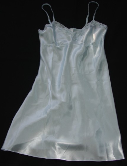 A WOVEN SATIN FINISH PETTICOAT FOR WOMEN.  DESIGNED TO COVER THE BODY FROM THE SHOULDERS TO ABOVE THE KNEE.  WITH NARROW ADJUSTABLE SHOULDER STRAPS.  WITH SHAPED BUSTLINE WITH LACE STYLE TRIMMING.  HEMMED AT BASE.  100 PERCENT POLYESTER.