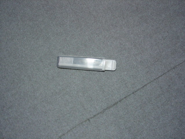 A PLASTIC TRAVEL TOOTHBRUSH, WHICH IS STORED IN THE HANDLE. PRESENTED IN A BAG AS PART OF A SET WITH A PAIR OF BRIEFS, AN EYE MASK, A NOTE BOOK A PENCIL AND A MIRROR.