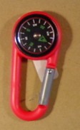 MAGNETIC COMPASS, ON A PLASTIC SPRING-CLIP KARABINER. APPROXIMATE OVERALL LENGTH 68mm. COMPASS DIMENSION 20mm.