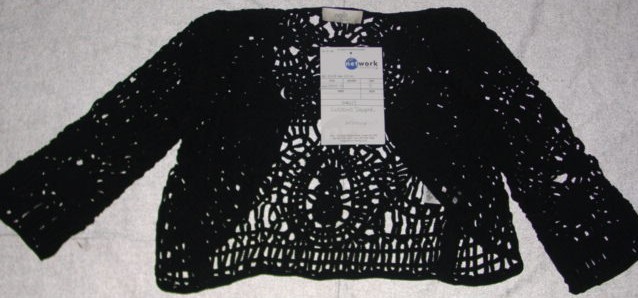 A BOLERO STYLE JACKET FOR WOMEN. DESIGNED TO COVER THE UPPER PART OF THE BODY FROM THE SHOULDERS TO THE WAIST. WITH ROUND NECK. WITH LONG SLEEVES. WITH SINGLE HOOK AND EYE FASTENING. GARMENT IS  MADE FROM A MESH STYLE FABRIC 100 PER CENT VISCOSE CONSTRUCTED BY STITCHED OVERLAPPING TAPE RIBBON TOGETHER AT INTERVALS.