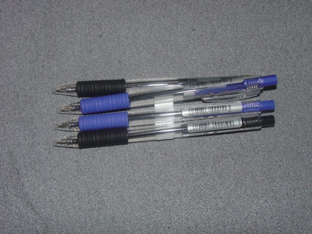 BLACK AND BLUE INK RETRACTABLE BALL POINT PENS. PENS HAVE A CLEAR PLASTIC BARREL WITH SOFT RUBBER GRIP ZONE. PENS ARE PACKAGED IN BOXES CONTAINING FIFTY PENS. THE PENS DO NOT HAVE A REPLACEABLE REFILL.