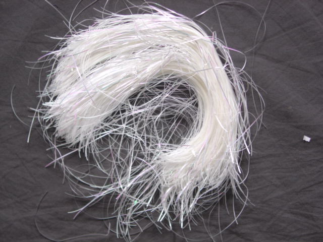A PLASTIC FOIL STRIP APPROX 1mm WIDE. INTENDED FOR DECORATION OF ART AND CRAFT WORK. OF POLYETHYLENE TEREPHTHALATE.   PACKAGED IN A PLASTIC PACK FOR RETAIL SALE.