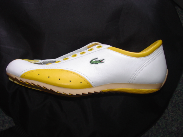 TRAINING SHOE. NOT COVERING THE ANKLE. UPPERS OF LEATHER. OUTER SOLES OF RUBBER. WITH LOGO ON HEEL, UPPER AND TONGUE. LACE UPS. INSOLE LENGTH NOT EXCEEDING 24 CMS. CIF PRICE MORE THAN 9 EURO. YELLOW AND WHITE IN COLOUR.