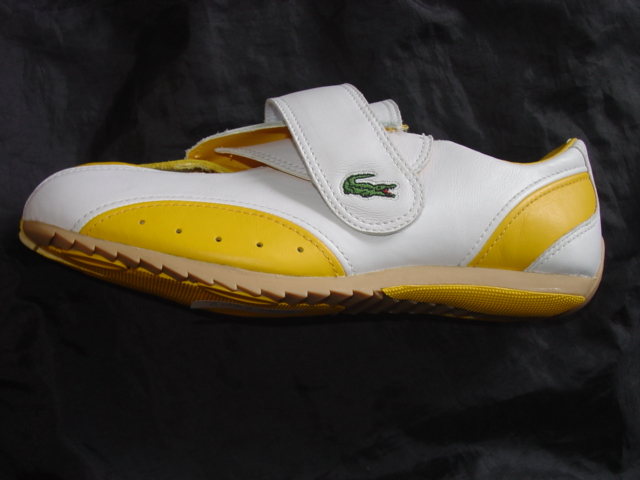 TRAINING SHOE. NOT COVERING THE ANKLE. UPPERS OF LEATHER. OUTER SOLES OF RUBBER. WITH LOGO ON HEEL, STRAP AND UPPER. VELCRO STRAP FASTENING. INSOLE LENGTH NOT EXCEEDING 24 CMS. CIF PRICE MORE THAN 9 EURO. YELLOW AND WHITE IN COLOUR.