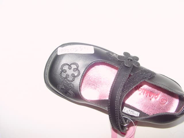 A CHILDS SHOE WITH AN UPPER OF PLASTIC AND A BUCKLE AND VELCRO FASTENING. FLOWER PATTERN AT THE SIDE AND FRONT OF THE SHOE AND ON THE BACK AND SOLE OF THE SHOE.  THERE IS A FLOWER PRESS STUD FASTENING. IN-SOLE LENGTH IS LESS THAN 24CMS.