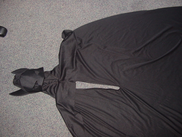 KNITTED CAPE WITH HOOD, WITH APPLIED EARS AND HOLES FOR THE EYES.  PACKAGED TOGETHER ALL IN ONE GARMENT AND BELT IN POLLY POPPER BAG WITH HANGER HOOK.