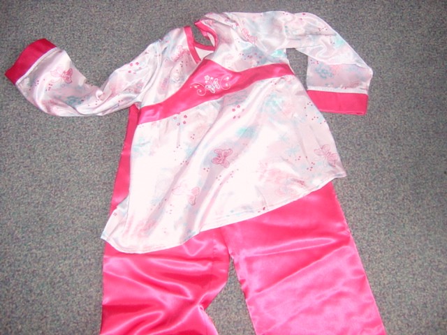 A PAIR OF WOVEN POLYESTER PYJAMAS FOR A GIRL WITH A V NECK TOP REACHING TO BELOW THE WAIST. THE TOP HAS A BUTTERFLY DESIGN AND LONG SLEEVES. THE TROUSERS ARE ELASTICATED WITH THE BUTTERFLY DESIGN ALONG THE EDGE OF EACH LEG. HEMMED AT LEG ENDS.