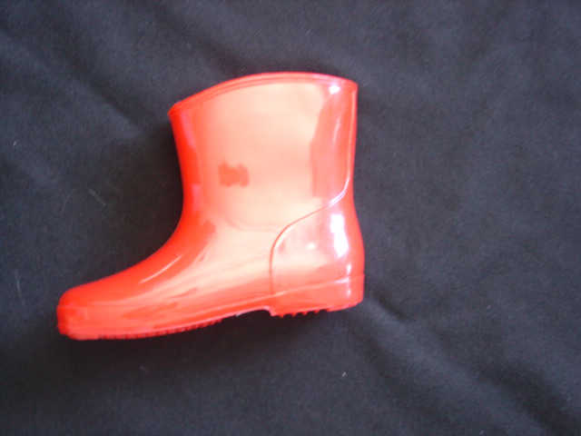 CHILDS WATERPROOF WELLINGTON BOOT. COVERING THE ANKLE BUT NOT THE KNEE. UPPER AND SOLE OF 1 PIECE MOULDED PVC. RED IN COLOUR.