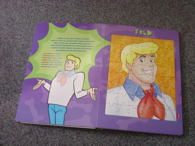 A BOUND BOOK FOR CHILDREN. CONTAINING 5  PRINTED PAGES WITH TEXT DESCRIBING DIFFERENT CHARACTERS. WITH A  JIGSAW PUZZLES FOR EACH ONE. ALSO CONTAINS A NUMBER OF STICKERS.