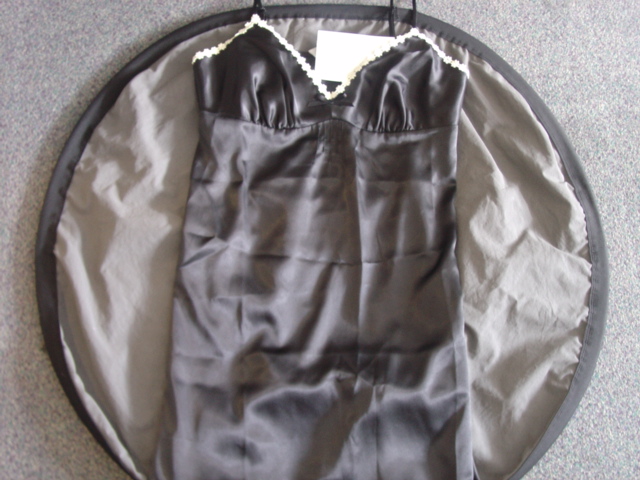 LADIES SATIN WOVEN PETTICOAT. DESIGNED TO COVER THE UPPER PART OF THE BODY FROM THE SHOULDERS TO ABOVE THE KNEE. WITH ADJUSTABLE SHOULDER STRAPS. WITH SHAPED BUST LINE AND SMALL EMBRIODED FLOWERS ALONG THE HEM. 100 PER CENT POLYESTER.