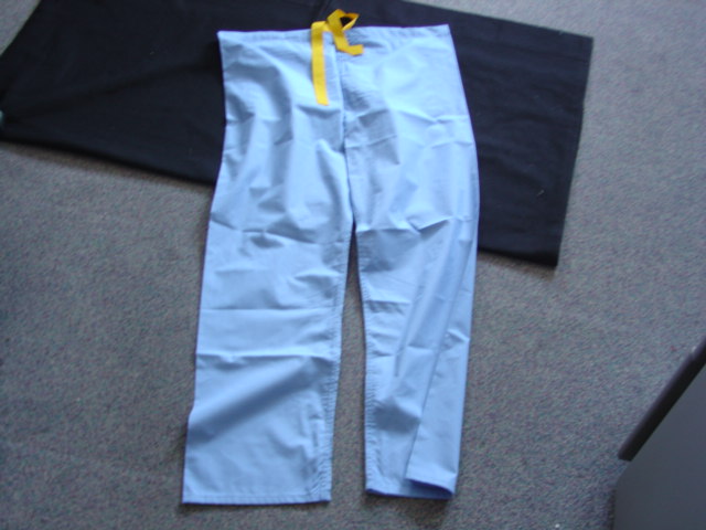 A PAIR OF REVERISBLE SCRUB SUIT TROUSERS FOR UNISEX. WITH A CONTRASTING DRAWSTRING AT THE WAIST. HEMMED AT WAIST AND LEG ENDS. WITH ONE PATCH POCKET TO REAR.OF 50 PERCENT COTTON AND 50 PERCENT POLYESTER. WITH SAFETY SEAMS.