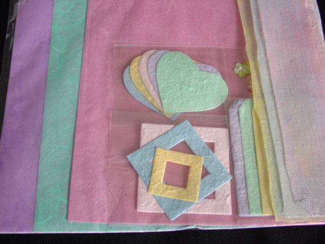 HAND MADE PAPER KIT. SIX SHEETS OF HAND MADE PAPER. WITH THREE DECORATIVE  LENGTHS OF FABRIC AND  AN ASSORTMENT OF DECORATIVE PAPER SHAPES . PACKAGED AS A KIT FOR SCRAPBOOK/CARD MAKING.
