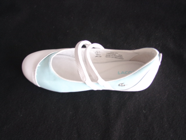 A FASHION SHOE FOR GIRLS. WITH LEATHER AND TEXTILE UPPERS. LEATHER PREDOMINATES. SLIP ON STYLE WITH TWO VELCRO STRAPS ACROSS THE BRIDGE. WITH RUBBER/PLASTIC SOLES. WITH A LOGO TO SIDE. OF AN IN-SOLE LENGTH OF LESS THAN 24 CMS. AQUA AND WHITE.