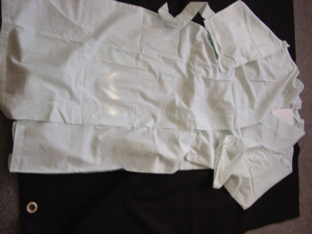 A WOVEN DRESSING GOWN FOR LADIES DESIGNED TO COVER THE BODY FROM THE SHOULDERS TO MID THIGH. WRAPOVER STYLE GOING RIGHT OVER LEFT WITH INNER TIES. WITH BELT LOOPS AND TIE BELT. WITH LONG SLEEVES HEMMED AT SLEEVE ENDS. HEMMED AT BASE OF GARMENT. EMBROIDERY  AND SEQUIN TRIM TO SLEEVE ENDS AND UPPER RIGHT HAND SIDE OF GARMENT, 100 PER CENT COTTON