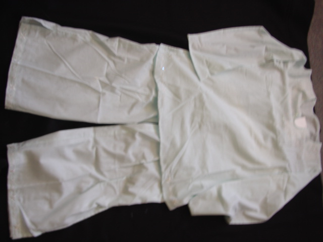 WOVEN PYJAMAS FOR WOMEN CONSISTING OF A TUNIC  STYLE TOP WITH LONG SLEEVES. HEMMED AT SLEVE ENDS. HEMMED AT BASE OF GARMENT WITH SLITS TO SIDE SEAMS. WITH VEE SHAPED NECKLINE. EMBROIDERED AND SEQUIN TRIM TO NECKLINE AND TO FRONT OF GARMENT AT THE BASE.PRESENTED WITH  A PAIR OF WOVEN TROUSERS REACHING TO THE ANKLES. WITH ELASTICATED WAISTBAND. WITH RIBBON BOW TRIM TO CENTRE FRONT. HEMMED, WITH SIDE SLITS AT LEG ENDS. EMBROIDERED AND SEQUIN TRIM AT LEG ENDS.100 PER CENT COTTONCOTTON