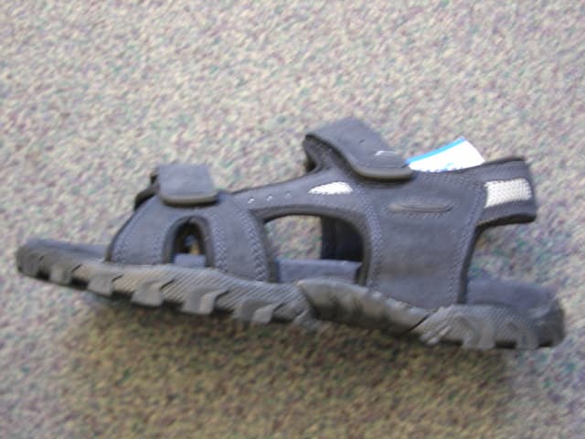 MENS SANDAL. UPPER THONG OF LEATHER. WITH 2 VELCRO FASTENING STRAPS ACROSS THE FOREFOOT AND A STRAP AROUND THE HEEL . OPEN TOED. WITH TEXTILE LINING. OUTER SOLES OF RUBBER. INSOLE LENGTH MORE THAN 24 CMS. SOLE AND HEEL HEIGHT MORE THAN 3CMS. NAVY IN COLOUR.
