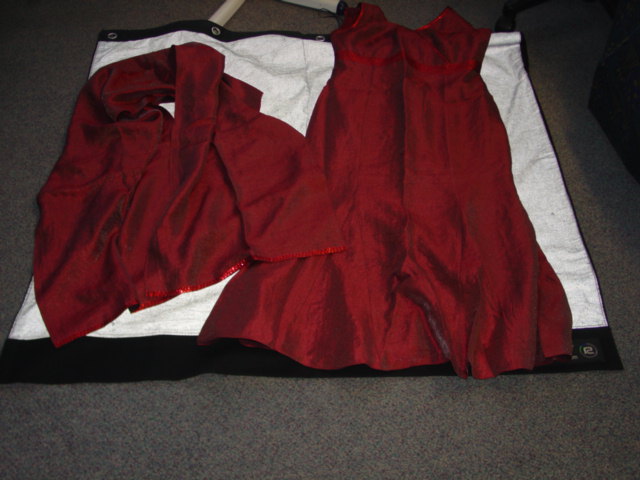 A FULL LENGTH  WOVEN EVENING DRESS. SLEEVELESS WITH A CROSS-OVER V-NECK. ZIP FASTENING TO REAR. WITH SEQUIN DETAIL TO EDGES AND UNDER BUST. FULLY LINED. HEMMEDPRESENTED WITH A MATCHING SCARF. OF 70 PERCENT VISCOSE, 19 PERCENT POLYESTER AND 11 PERCENT POLYAMIDE.