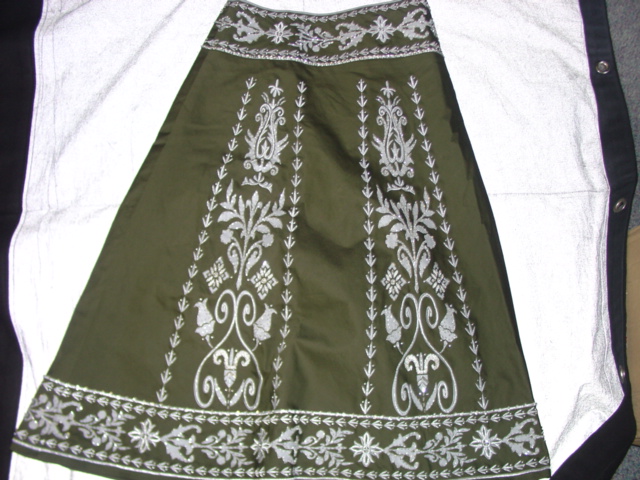 LADIES WOVEN PANELLED SKIRT. REACHING DOWN FROM THE WAIST TO BELOW THE KNEE.  HEMMED WAIST. HEAVILY EMBROIDERED. DECORATED WITH BEADS AND SEQUINS.  WITH ZIPPED OPENING. WITH HOOK AND EYE FASTENING AT WAIST. HEMMED AT BASE.  96 PERCENT COTTON 4 PERCENT ELASTANE. FULLY LINED