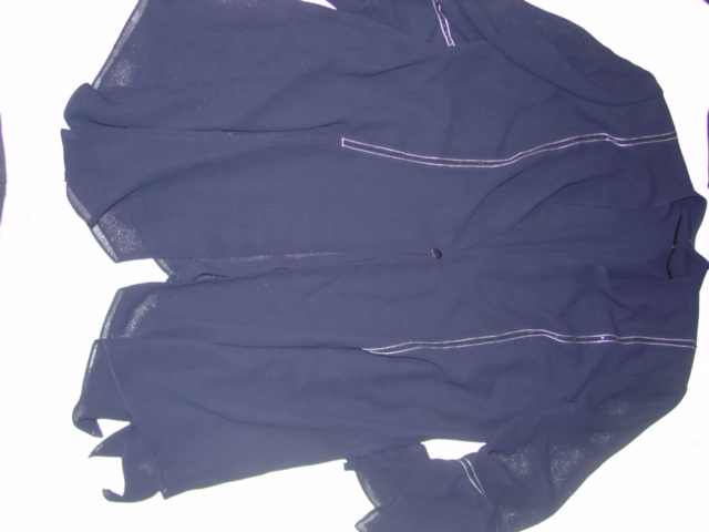 WOVEN LONG LINE JACKET FOR WOMEN.  REACHING DOWN TO BELOW THE HIP.  V-NECK. COMPLETE FRONT OPENING FASTENED RIGHT OVER LEFT BY SINGLE BUTTON.  LONG SLEEVES WITH FLARED HANDKERCHIEF STYLING AT SLEEVE ENDS AND AT BASE WITH LARGE SPLITS EXTENDING FROM BASE.  WITH SHOULDER PADS.  LINED. DECORATED WITH CONTRAST STITCHING AND BEADING.  100 PERCENT POLYESTER
