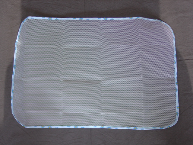 A KNITTED NET PRODUCT TO FACILITATE THE IRONING OF DELICATE FABRICS. A KNITTED MESH  OF MAN-MADE FIBRE MEASURING 60CM X 40CM APPROX. WITH ROUNDED CORNERS. BOUND AROUND COMPLETE EDGE.