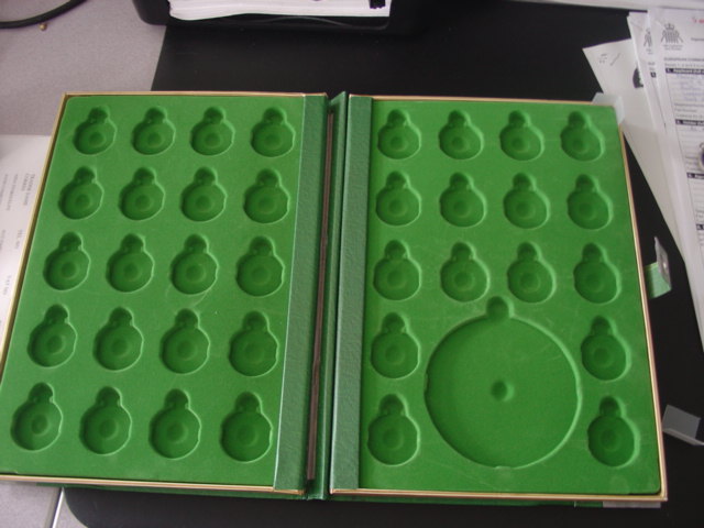 AN COLLECTION ALBUM FOR A CHILD. DESIGNED TO ORGANISE AND STORE COINS COLLECTED FROM A MAGAZINE. MOULDED SECTIONS TOO HOLD UP TO 36 COINS AND A PLASTIC PRINTED CODE CRACKER WHICH IS ALSO COLLECTED WITH THE MAGAZINE. MADE FROM PAPERBOARD WITH LOGO OF FILM ON THE FRONT. CODE CRACKER AND COINS CLASSIFIED SEPARATELY.