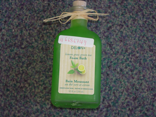 LEMON GRASS AND GREEN TEA FOAM BATH. PACKAGED FOR RETAIL SALE IN A 8.5 FL OZ 250 ML GLASS BOTTLE WITH CORK STOPPER AND TRIMMED WITH RAFFIA ARROUND THE NECK OF THE BOTTLE. PART OF A SPA SET IN AN IRON WIRE BASKET, THE OTHER PARTS OF WHICH HAVE ALL BEEN CLASSIFIED SEPARATELY.