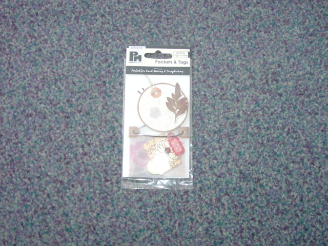 PAPER TAGS/LABELS. PRINTED IN VARIOUS DESIGNS AND SIZES. WITH CORD ATTACHED. WITH OPTIONAL STICKY SMALL PAD FOR ATTACHING TO CARDS FOR DECORATION. PACKAGED IN A POLY BAG FOR RETAIL SALE.