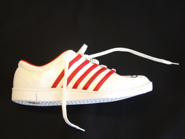 A LACE-UP LEATHER TRAINING SHOE FOR LADIES. NOT COVERING THE ANKLE.  WITH RUBBER SOLES. WITH BRASS EYELETS. WITH AN INSOLE MEASURING 25 CMS. WITH A CIF PRICE OVER 7.5 EUROS. WHITE WITH NARROW RED STRIPES AND HEEL TRIM. LOGO IMPRINTED INTO RUBBER HEEL. NO EVIDENCE OF SPECIAL TECHNOLOGY.