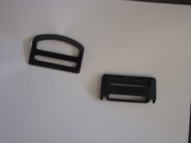 A GENERATION ADJUSTER RING AND COVER. THE ITEMS ARE USED ON SEATBELTS AS A  HEIGHT ADJUSTER.  THE PARTS SNAP TOGETHER TO BE USED AS ONE PART .