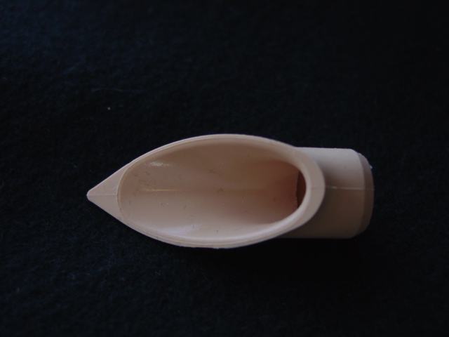 SILICONE RUBBER BACK PLATE. THE COMPONENT FORMS PART OF A  LARYNGEAL MASK  WHICH IS USED AS A MEDICAL ANAESTHETIC  DEVICE. PHYSICAL DIMENSIONS APPROXIMATELY 50MM IN LENGTH WITH A DIAMETER OF 15MM.