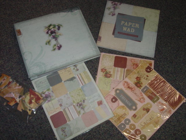 SCRAPBOOK KIT. KIT CONSISTS OF A POST BOUND EXPANDABLE PRINTED COVER 8 X 8 INCH (20.3 X 20.3 CM) ALBUM WITH 10 CLEAR PLASTIC POCKETS WITH ACID AND LIGNIN FREE PAPER INSERTS TO KEEP DECORATED SCRAPBOOK PAGES SEPARATED AND PROTECTED, 40 SHEETS OF PRINTED 8 X 8 INCH (20.3 X 20.3 CM) PAPER, PRINTED CARDBOARD LETTERS, 3 SHEETS OF PRINTED DIE CUT SHAPES. ALL ITEMS IN THIS KIT ARE PRINTED IN COORDINATING COLOURS. PACKAGED IN A PRINTED CARDBOARD HALF BOX WITH CLEAR PLASTIC LID AND SEALED IN A CELLOPHANE WRAP FOR RETAIL SALE.