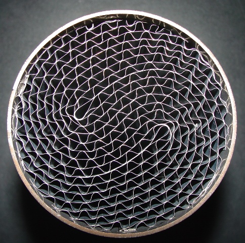 A CATALYTIC FILTER. FORMED WITH A HONEYCOMB FILTER. THE HONEYCOMB SUBSTRATES ARE FORMED FROM ALTERNATE LAYERS OF CORRUGATED AND FLAT METALS FOIL AND ARE CONTAINED WITHIN A METAL HOUSING. HIGH QUALITY HEAT AND CORROSION RESISTANT STEELS ARE USED THROUGHOUT. THEY ARE USED IN CATALYTIC FILTERS FOR THE PURIFICATION OF EXHAUST GASES FROM INTERNAL COMBUSTION ENGINES. HOWEVER THE CATALYTIC SUBSTRATE HAS NOT BEEN APPLIED AT THIS TIME.