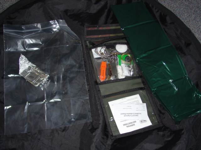 A KIT DESIGNED TO BE USED FOR SURVIVAL PURPOSES. THE KIT CONTAINS A PLASTIC WATER BAG, A TEALIGHT CANDLE, A POUCH OF 10 MATCHES, A PLASTIC SHEET SLEEPING BAG, BRASS WIRE, A FOIL FOOD TRAY, A COMPASS, WHISTLE, NYLON CORD, A SMALL PEN KNIFE, A PLASTIC SIGNALING MIRROR, 10 WATER PURIFYING TABLETS, A FLINT, A COMANDO SAW, AN INSTRUCTION BOOKLET, AN ACCIDENT REPORT PAGE AND A SMALL FISHING SET WITH LINE, HOOKS AND WEIGHTS. ALL PUT TOGETHER IN A TEXTILE POUCH WITH PLASTIC SHEETING POCKETS INSIDE THIS IS THEN PACKAGED IN A PLASTIC BAG WITH CARDBOARD HEADER FOR RETAIL SALE.