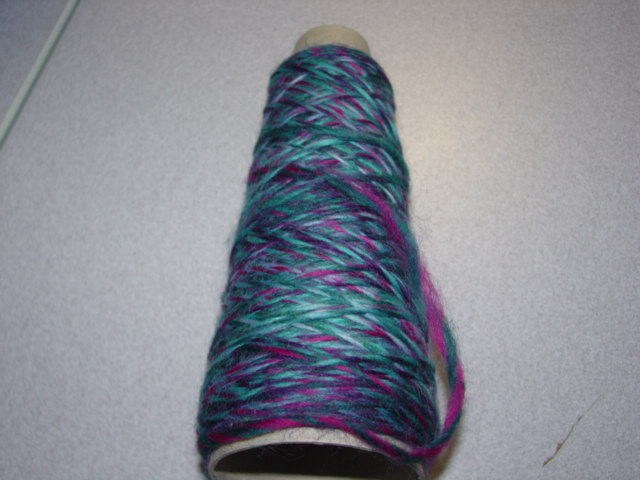 SPUN YARN OF SINGLE WORSTED COMBED WOOL WOUND ONTO A CONE. NOT PUT UP FOR RETAIL SALE. YARNS OF DIFFERENT COLOURS WITH APPROX 75 TURNS PER METRE. APPROX WEIGHT 10KG. 100 PERCENT WOOL.
