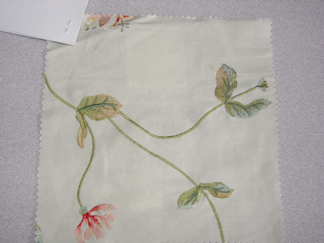 A WOVEN FABRIC WITH EMBROIDERED FLORAL DESIGN. OF 55 PERCENT LINEN, 30 PERCENT COTTON AND 15 PERCENT RAYON. WITH VISIBLE BACKGROUND. OF A VALUE EXCEEDING 17.50 EURO PER KG. WIDTH 134CMS. NOT HAND-MADE.