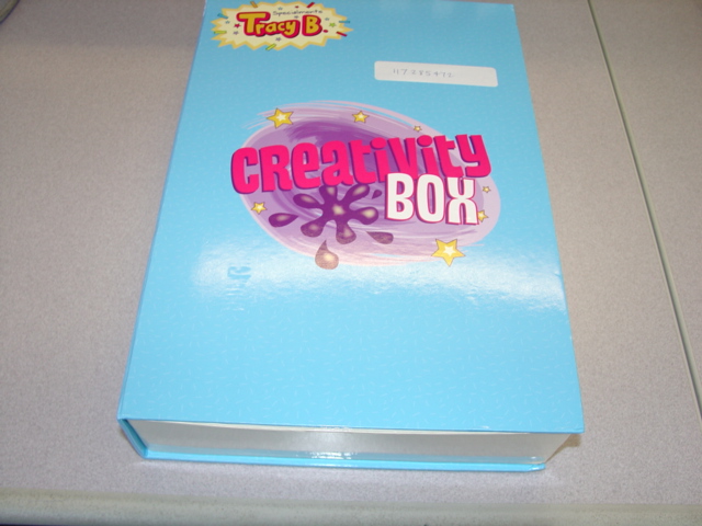 A NON CORRUGATED PLASTICISED PAPERBOARD STORAGE BOX FOR VARIOUS STATIONERY. WITH REMOVEABLE TRAY WITH FLOCK TEXTILE INSERT WHICH IS SPECIFICALLY SHAPED TO HOLD THE VARIOUS ITEMS. WITH A SMALL LOCK AND KEY. 33.5 x 22.5 x 6.5 CMS APPROX. WITH DECORATION ON THE OUTSIDE. DESIGNED WITH A CHILD'S TELEVISION PROGRAMMES CHARACTER NAME.