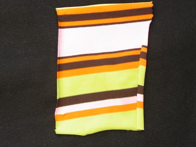A WEFT KNITTED FABRIC. WITH A WIDTH OF 157 CMS. MADE FROM 92 PER CENT NYLON 8 PER CENT ELASTANE. DYED WITH STRIPE PATTERN.