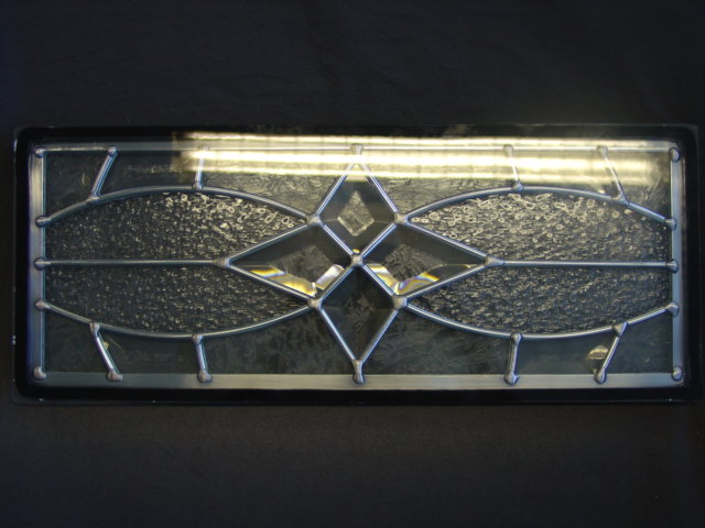 GLASS GLAZING FOR BUILDINGS. CONSISTING OF TRIPLE GLAZED SEALED UNIT OF TOUGHENED GLASS . IS MADE AS THREE SEPARATE GLASS SHEETS, THE CENTRE PANE BEING LEADLIGHT MADE OF SMALL GLASS PIECES HELD TOGETHER IN A ZINC FRAME  AND THEN SEALED TOGETHER WITH A SPECIALIST STRIP.THE UNIT IS SEALED AIRTIGHT AND HAS GAS PUMPED INTO THE CENTRE. THE UNITS CAN BE USED IN DOORS AND WINDOWS OF DOMESTIC AND COMMERCIAL PROPERTIES TO OFFER INSULATING FITTINGS.