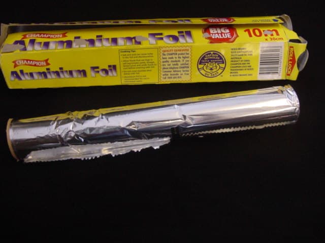 A ROLL OF ALUMINIUM FOIL, PACKED FOR RETAIL SALE IN A PRINTED BOX. WITH VARYING THICKNESSES OF 12, 15 AND 9 MICRONS - LESS THAN 0.021 MM.