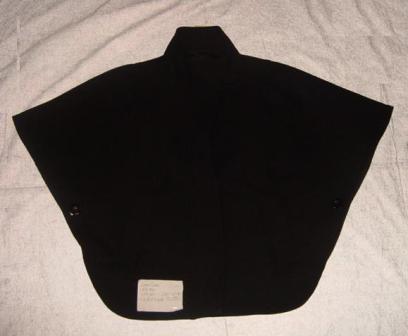 WOVEN CAPE STYLE COAT FOR WOMEN.  DESIGNED TO COVER THE UPPER BODY FROM THE SHOULDERS TO THE WAIST.  MATERIAL CONTENT: OUTER - 50 PERCENT POLYESTER, 26 PERCENT ACRYLIC, 24 PERCENT WOOL; LINING - 100 PERCENT POLYESTER.  FULL FRONT OPENING FASTENED WITH A ZIP WITH A PROTECTIVE FLAP GOING RIGHT OVER LEFT.  PROTECTIVE FASTENS WITH A PRESS STUD AT THE BOTTOM AND A BUTTON AT THE COLLAR.  HAS DEEP STAND UP COLLAR.  HAS TWO OUTER POCKET A THE FRONT.  SLEEVED FORMED BY TWO BUTTONS THAT ARE FASTENED UNDER THE ARMS.  BLACK.  IMPORTED ON A HANGER WHICH IS CLASSIFIED SEPERATELY BECAUSE IT IS CLEARLY SUITABLE FOR RE-USE AS PART OF A CONTRACTED HANGER RE-USE PROGRAMME, WHERE THE HANGER IS DESIGNED TO BE USED FOR THE TRANSPORT, IMPORT AND STORAGE OF GARMENTS ON A MINIMUM OF FIVE OCCASSIONS.