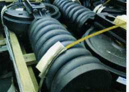 IDLERS, DESIGNED TO BE INSTALLED AT THE FRONT OF A CRUSHING MACHINE TRACK FRAME TO GUIDE THE TRACK LINK ASSEMBLY.  MADE FROM CAST STEEL THE IDLERS ARE SPECIFICALLY SHAPED AND DESIGNED TO FIT A PARTICULAR MODEL OF CRUSHING MACHINE.